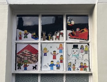 Window decorated with drawings of Christmas scenes