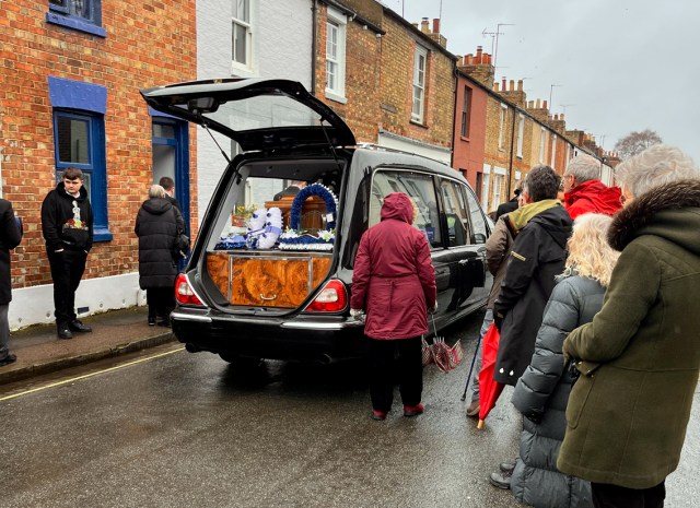 Hearse outside house in Bridge Street with family and residents gathered to pay their respects